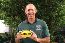 Sam Kakazu holding "BEES>me" sticker